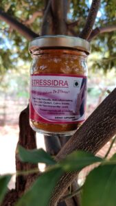 Stressidra" is a yellow-colored powder supplement made from pure root turmeric. The text on the label reads "Stressidra - Curcumin enriched turmeric for therapeutic benefits by Bagdara Farms
