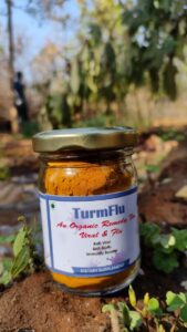 Turmflu bottle with yellow powder containing pure root turmeric dietary supplement for boosting immunity and managing symptoms of viral infections