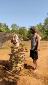 Volunteer Patrick Neale from New Zealand bonding with indigenous horse Bhura at Bagdara Farms